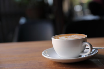 cappuccino or Latte art coffee made from milk on the wood table in coffee shop
