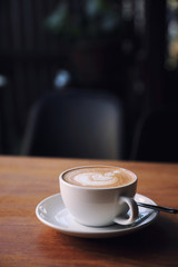 cappuccino or Latte art coffee made from milk on the wood table in coffee shop