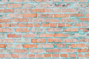 Obraz premium Brick wall. Old brick. Peeling paint. Light pink and gray.