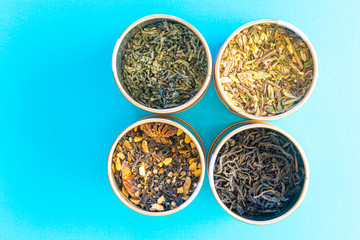 samples of dried loose tea on a blue background