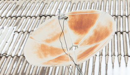 Satellite dish, parabola rooftop receiver, rusty with time