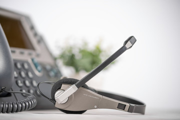 VOIP headset headphone phone, background for support service, assistance, call center. Light...