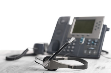 Office light background VOIP headset headphones telephone on office desk concept for communication,...