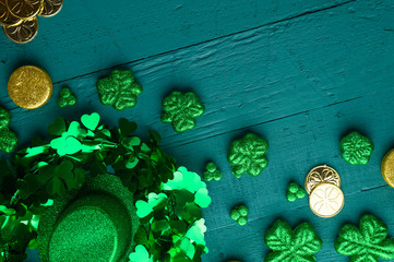 Traditional Irish holiday St. Patrick's Day, March 17th celebration, with accessories for teething on a green wooden background.