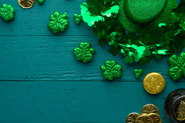 March 17, St. Patrick's Day.Irlandian holiday, Flat lay green background with coins, clover and hat.