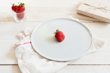 Health products. Green tea and strawberries. Food photo in high key. Tea set and gifts.
