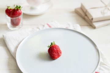 Health products. Green tea and strawberries. Food photo in high key. Tea set and gifts.