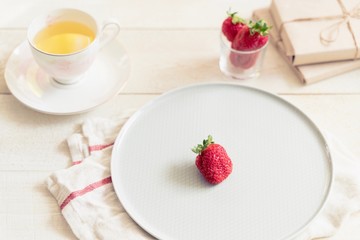 Health products. Green tea and strawberries. Food photo in high key. Tea set and gifts.