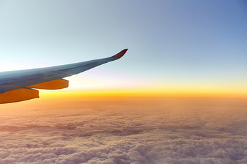 Wing of an aeroplane with sunset