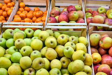 Apples and tangerines for sale at a market