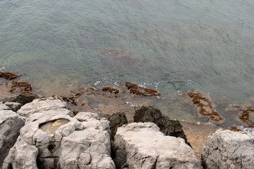 Rocky shore and water of the Mediterranean Sea on a summer day. Natural background