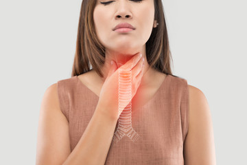 Asian women have symptoms of burning sensation on a gray background