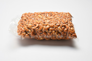 Transparent plastic package of cashews nut on white background