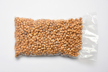 Transparent plastic package of roasted chickpeas, Turkish leblebi on white background