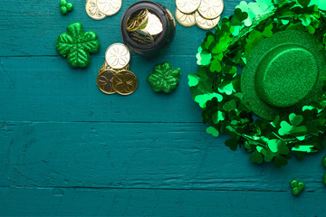 Saint Patrick, top view on a green wooden background, with accessories for a celebration