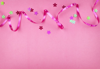 Wrapping ribbon and sequins flowers on pink paper