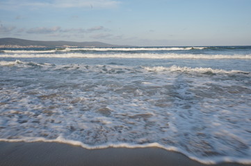 Daylight, summer day, light breeze on the seashore, incident waves on the shore.