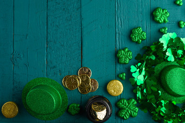 Saint Patrick, top view on a green wooden background, with accessories for a celebration