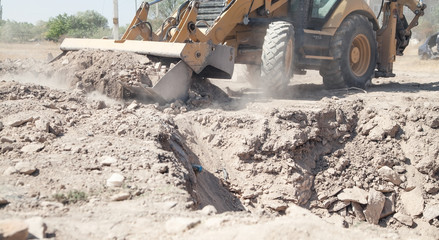 Excavator works at a construction site.
