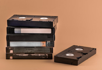 VHS video cassettes on color background with copy space. Stacked old VHS tapes. Highly popular old...