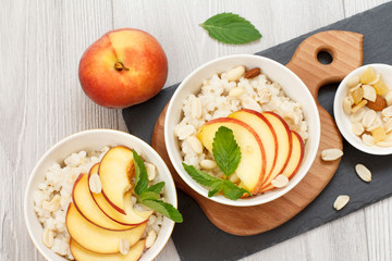 Sorghum salad with nuts and fresh peach on stone board.