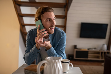 Handsome man talking on phone with his girlfriend