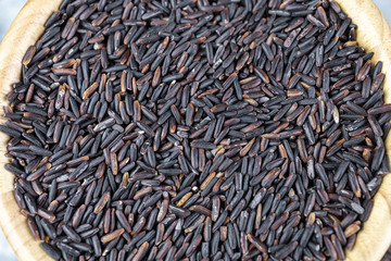 Rice berry in wooden bowl.