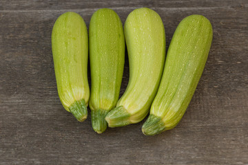 Zucchini benefits concept. Zucchini on wooden background