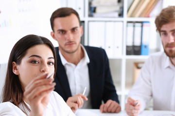 Beautiful brunette woman make some marks on screen or glass wall with silver pen. Fresh view discuss problem review situation look at new angle professional training memo graph or chart concept