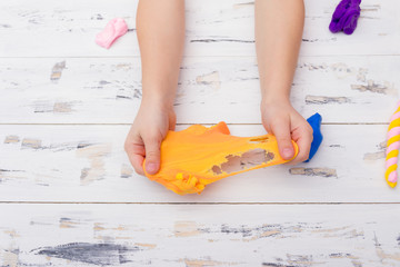 Little girl sculpts toy out of clay. Education concept.