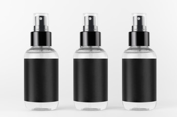 Three transparent spray bottles for cosmetics product with black blank label on white background, mock up for branding, advertising,  design.