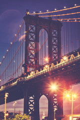 Manhattan Bridge with lens flares seen from Brooklyn at dusk, color toned picture, New York, USA.