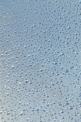 Wet glass water drops background texture pattern.