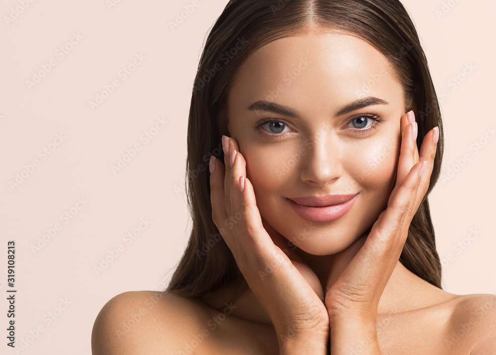 Wall mural beautiful woman face close up natural make up hand touching face beauty smile