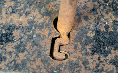 Vintage warded lock with semi inserted key that fits.