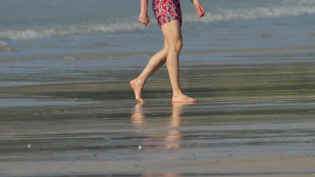 Barefoot tropical beach walking