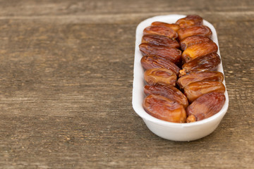 Benefits of Dates. Dried Dates on wooden background