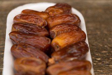 Benefits of Dates. Dried Dates on wooden background