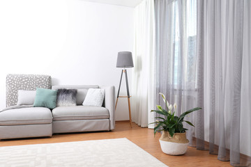 Fototapeta na wymiar Window with stylish curtains in living room interior