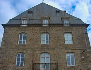 Fototapeta na wymiar Traditional french stone building with many windows