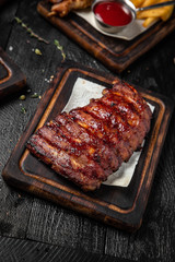 Roasted Honey Glazed Rack of Pork Ribs. Octoberfest party dinner. Festive table with delicious food on black boards. Octoberfest party dinn