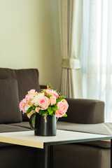 Vase flower on table with pillow and sofa decoration interior