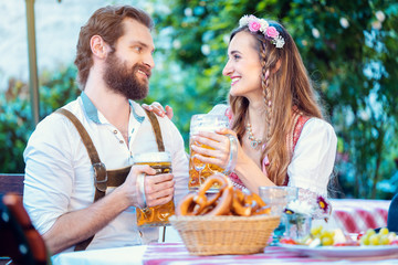 Couple in Bavaria enjoying beer and food in a pub