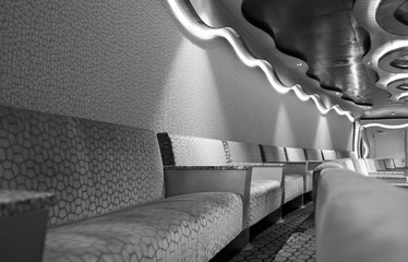 Sofas or seats in row with wall and ceiling inside theatre or show lounge on modern cruise ship...