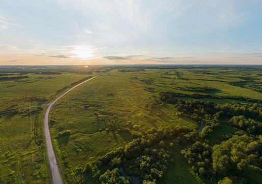 Road among forests and fields located on the border of the Ural and Siberia. Aerial, summer, sunny © flyural66