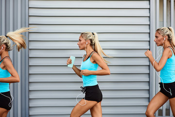 Modern sportswoman jogging in the urban area. Conceptual photo.