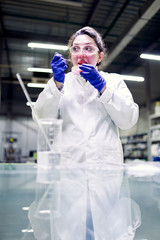Laboratory woman in glasses and petri dish in her hands conducts experiments
