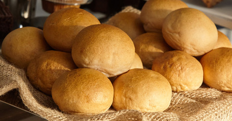 Freshly baked buns on a tray,.Sackcloth.Fresh bread from the bakery. Healthy rustic food.