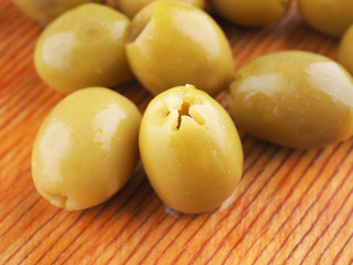 green olives on a wooden board