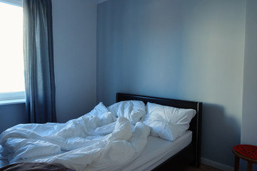 Fototapeta na wymiar Morning empty bed with white blankets
